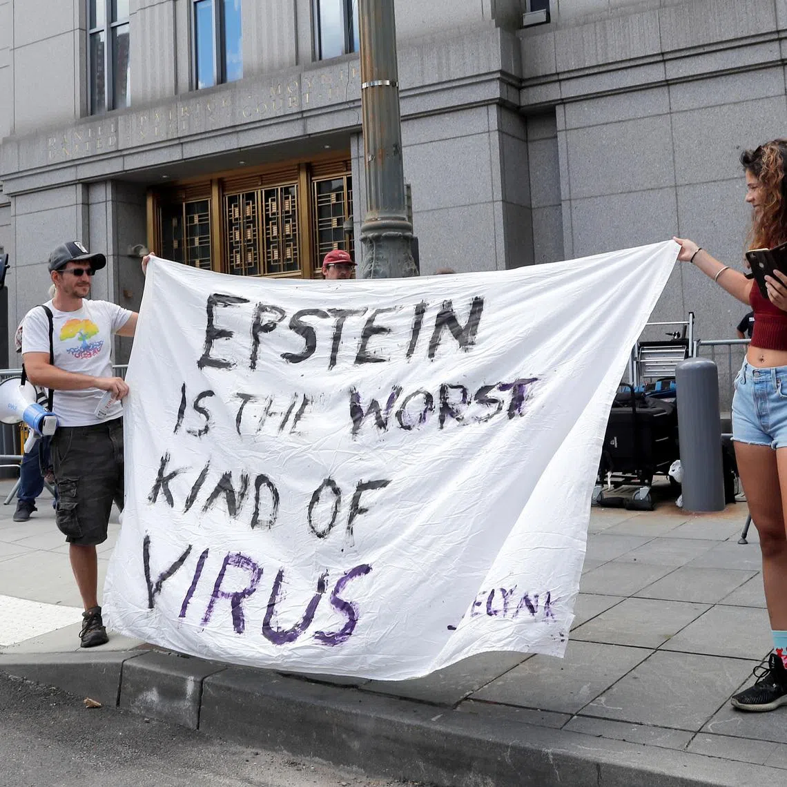 Protesters and members of the news media gather outside Manhattan Federal Court, during the arraignment hearing of Ghislaine Maxwell for her role in the sexual exploitation and abuse of minor girls by Jeffrey Epstein, in the Manhattan borough of New York City, New York, U.S. July 14, 2020. REUTERS/Mike Segar