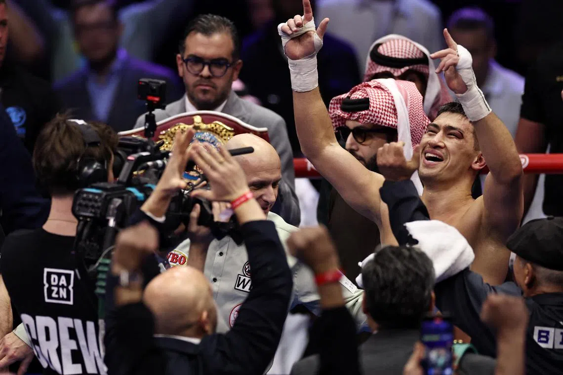 Dmitrii Bivol celebrates after winning his fight against Artur Beterbiev.