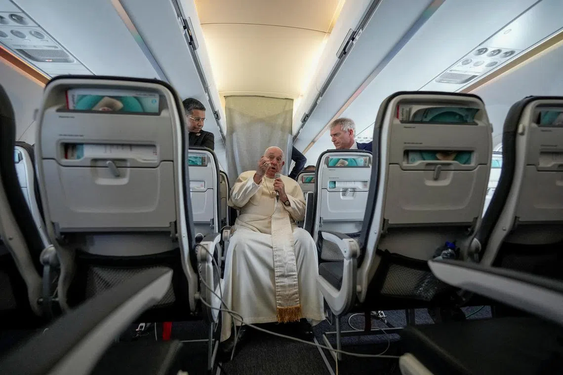FILE PHOTO: Pope Francis talks to journalists on the flight back to Rome at the end of his four-day visit to Belgium and Luxembourg, September 29, 2024. Andrew Medichini/Pool via REUTERS/File Photo