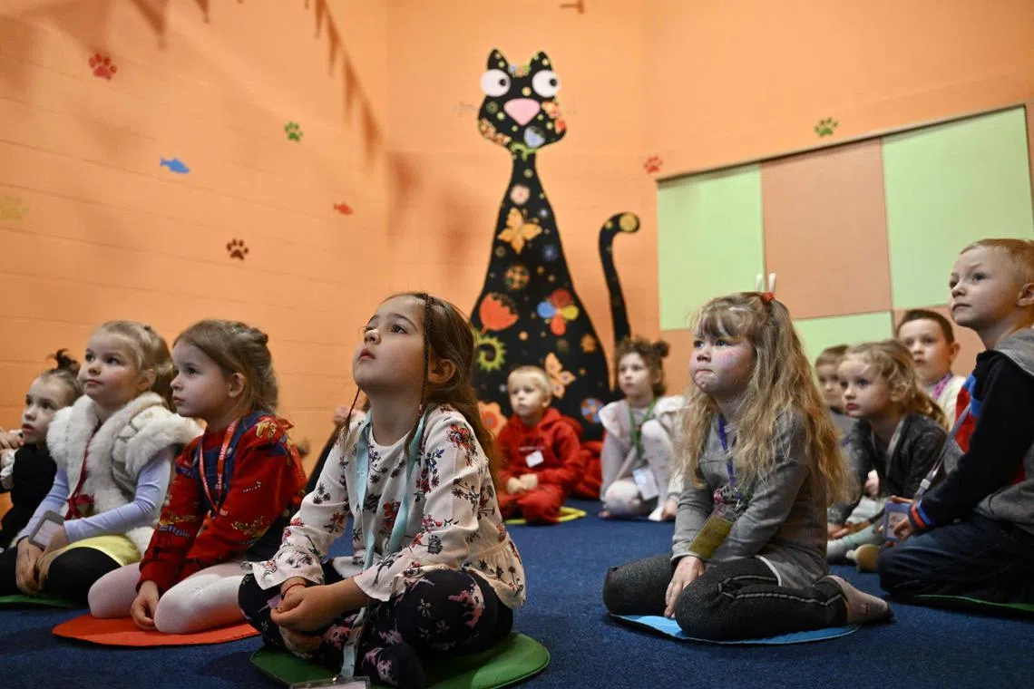 Children play in an air-raid shelter in the cellar of a kindergarten in Kyiv on March 20.