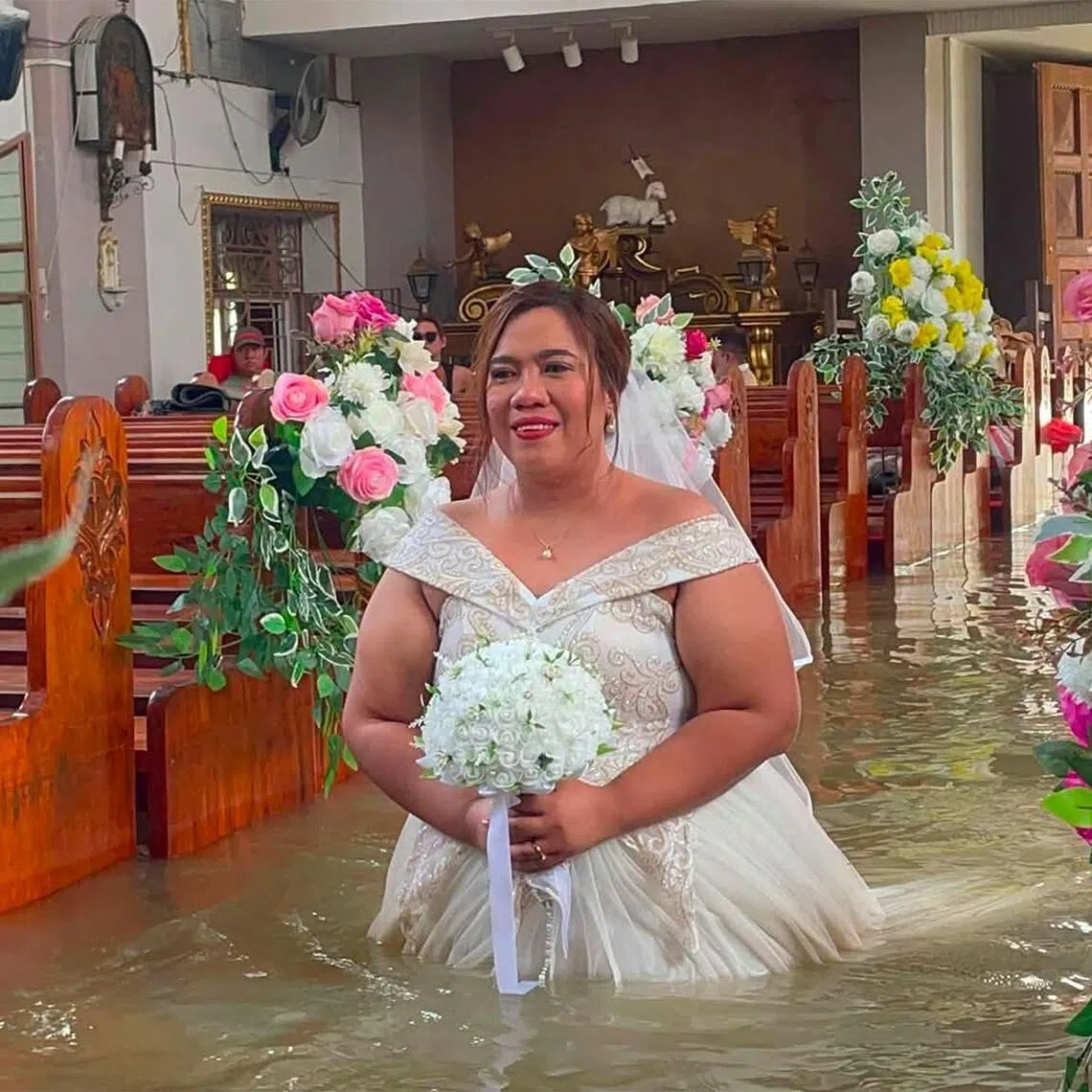 Bride Leian Lieza Galang walking down the aisle during her wedding ceremony in a flooded church in Hagonoy town on Sept 1.