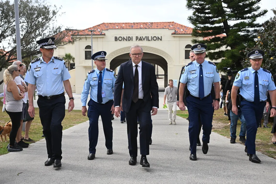 Australian PM Anthony Albanese (centre) called the Bondi Beach attack a “dark moment for our nation,” ​and said police and security agencies were thoroughly checking the motive behind the attack.