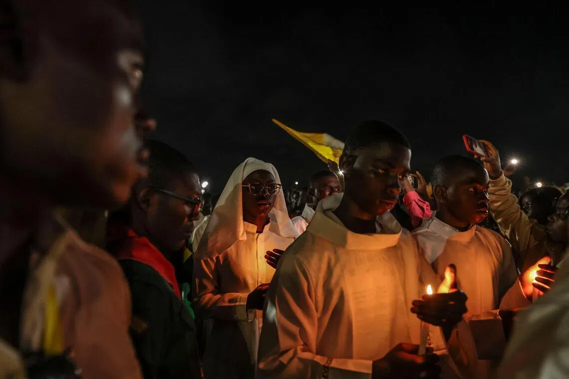 Altar servers lead a night vigil on the fifth day of Pope Leo’s 11-day visit to Africa in Yaounde, Cameroon. 
