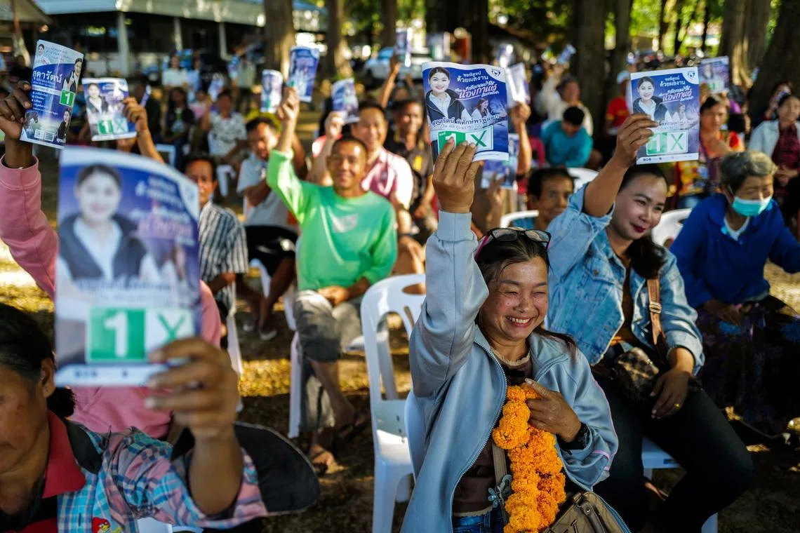 People hold up election campaign brochures of Sudarat Pitakpornpunlop, a parliamentary candidate for the Bhumjaithai Party, during her election campaign rally in Woen Buek village, Khong Chiam district, Ubon Ratchathani province, Thailand, January 24, 2026. REUTERS/Athit Perawongmetha