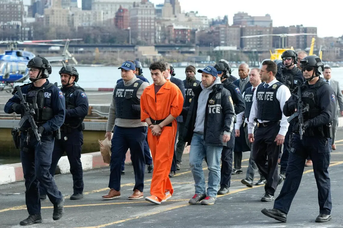 Luigi Mangione was escorted off a helicopter that landed in Lower Manhattan by a large group of police officers, with New York City Mayor Eric Adams a few steps behind.
