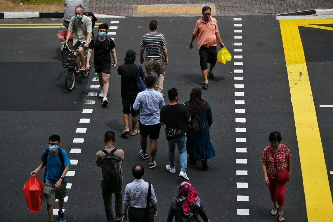 People crossing a traffic junction along Sims Avenue on 3 Aug 2022.