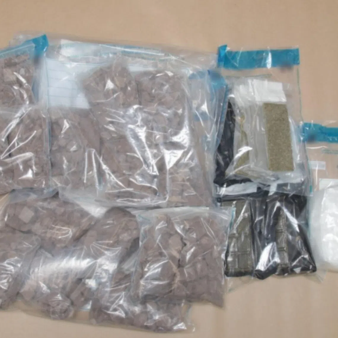 ICA officers discovered sealed packets labelled as commercial biscuits, suspected to contain controlled drugs, in the rear box of a Malaysia-registered motorcycle.