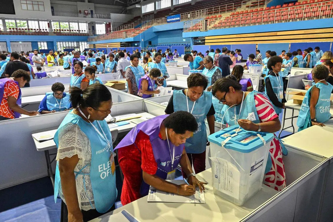 Election Commission officials preparing to open ballot boxes during Fiji's general election in Suva on Dec 14, 2022. 