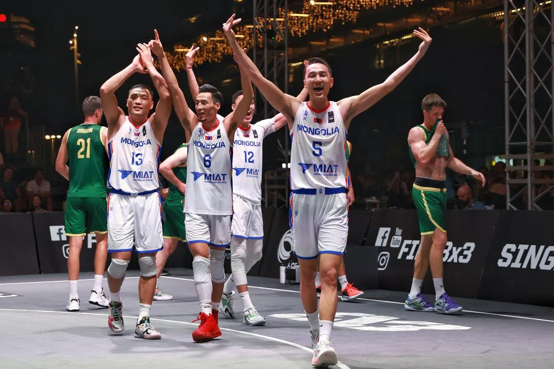 (L-R) Mongolia’s Delgernyam Davaasambuu (#13), Dulguun Enkhbat (#6), Enkhbaatar Onolbaatar (#12) and Anand Ariunbold (#5) celebrate after winning the men’s final of FIBA 3x3 Asia Cup 2023 at OCBC Square on April 2, 2023. ST PHOTO: KEVIN LIM dlbas02
