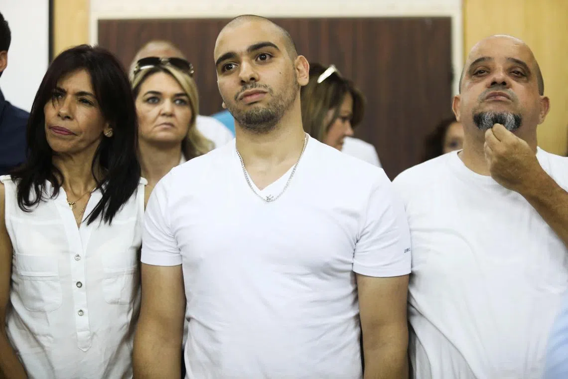 FILE PHOTO: Former Israeli soldier Elor Azaria (C), who was convicted of manslaughter and sentenced to 18 months imprisonment for killing a wounded and incapacitated Palestinian assailant, waits to hear the ruling at an Israeli military appeals court in Tel Aviv, Israel July 30, 2017. REUTERS/Dan Balilty/Pool/File Photo