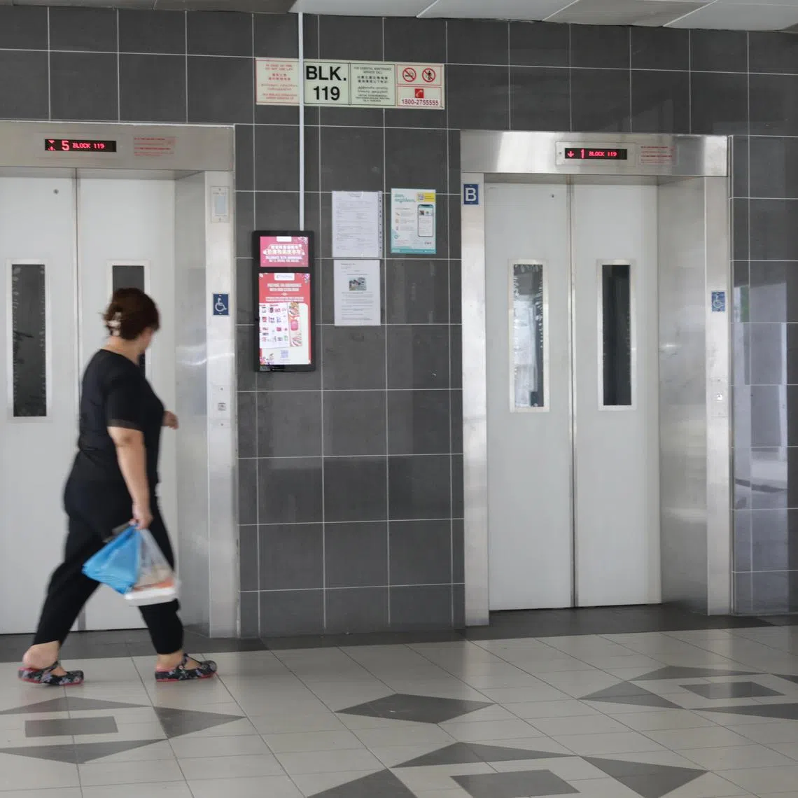 ST20230113_202343235921/yflift/Ryan Chiong
A resident of Block 119 Marsiling Rise at the lift landing.
Block 115 and Block 119 Marsiling Rise will undergo lift upgrading after 95 per cent of residents voted in favour of the project at the two Housing Board blocks. Currently, the lifts at the blocks stop only at the first, fifth, ninth and 12th storeys.