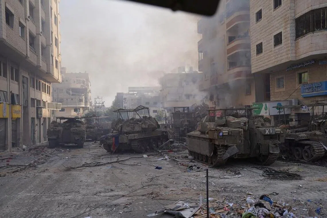 Israeli military vehicles manoeuvre during the ongoing ground operation of the Israeli army against Palestinian Islamist group Hamas, in the Gaza Strip as seen in a handout picture released by the Israel Defense Forces on November 13, 2023. Israel Defense Forces/Handout via REUTERS