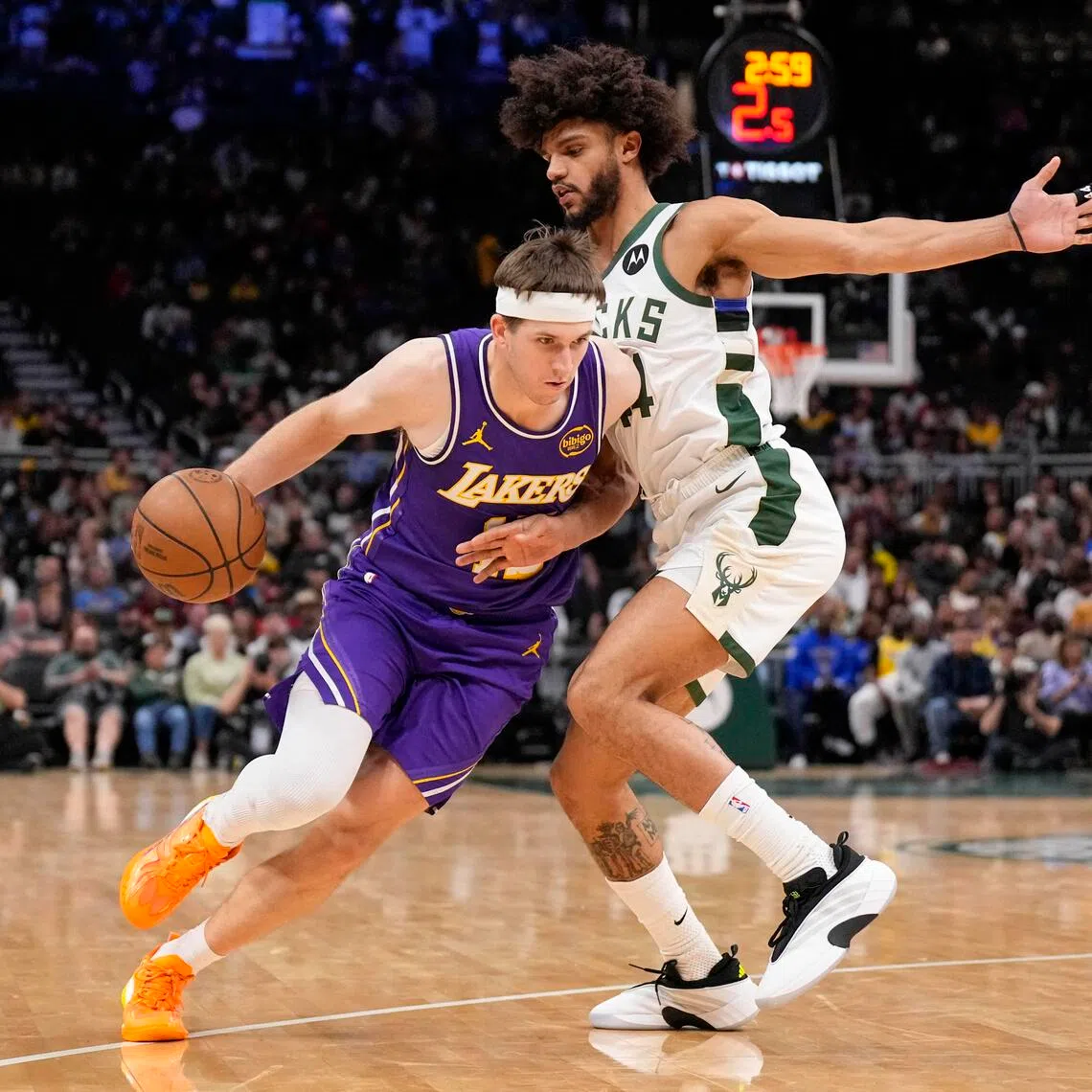 Los Angeles Lakers guard Austin Reaves drives towards the basket against Milwaukee Bucks guard Andre Jackson Jr. during the fourth quarter at Fiserv Forum.