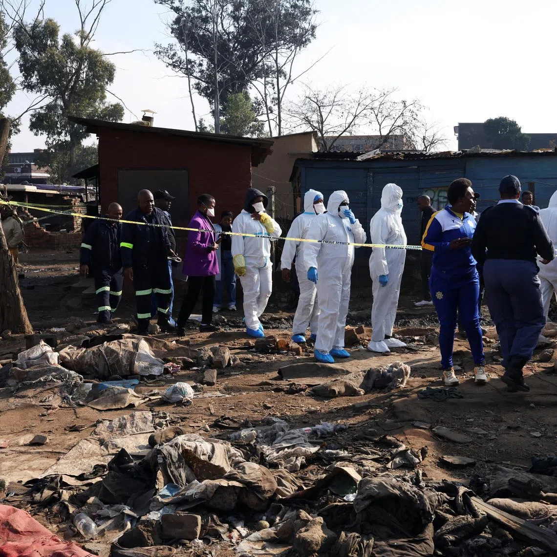 Members of the forensics team arrive at the scene after, according to the police, gunmen opened fire at an informal settlement in Cleveland, Johannesburg, South Africa,  June 10, 2026. REUTERS/Siphiwe Sibeko