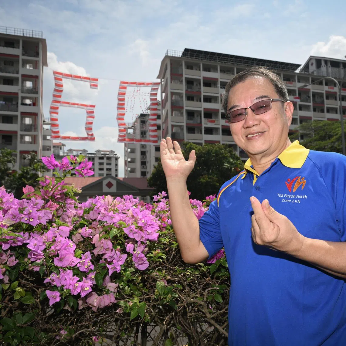 ST20250808_202518400279/smflag09/Shintaro Tay/Shermaine Ang/

Mr Ong Kok Chee, 63, pictured with the ?60? flag display of Singapore flags between block 107 and 109 Toa Payoh Lorong 1 on Aug 8, 2025. 

ST PHOTO: SHINTARO TAY