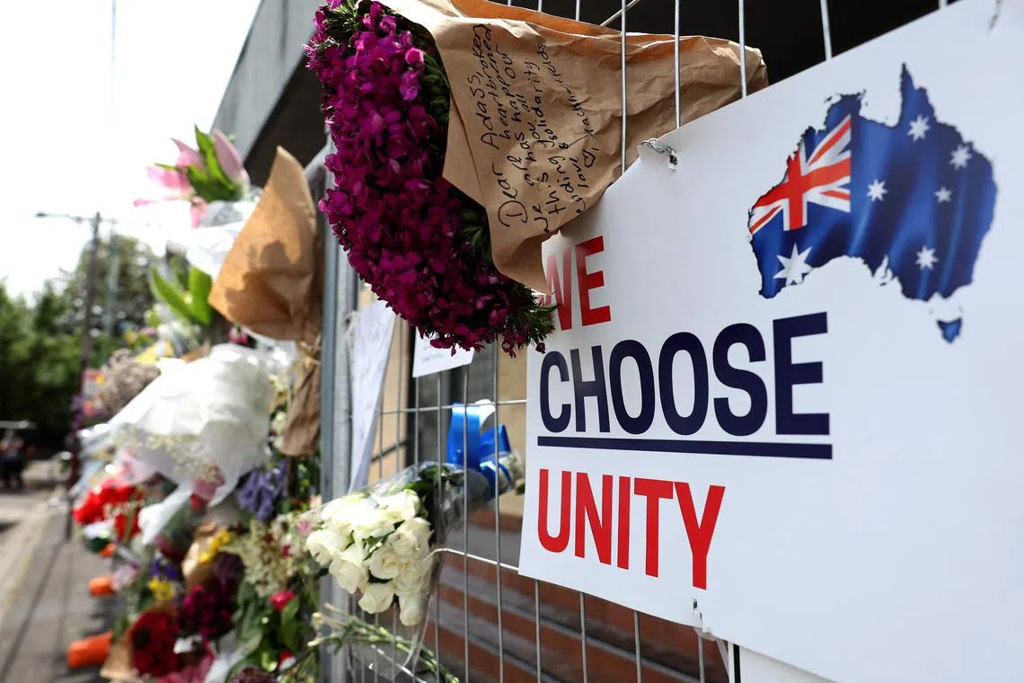 Messages and flowers are seen attached to the fence at the Adass Israel Synagogue on Dec 9.