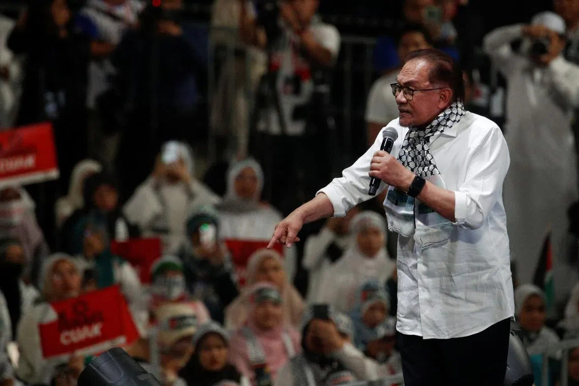 Malaysia Prime Minister Anwar Ibrahim delivers his speech during a solidarity gathering to show support for Palestinians, amid escalating conflict between Israel and Hamas, in Kuala Lumpur, Malaysia, October 24, 2023. REUTERS/Hasnoor Hussain