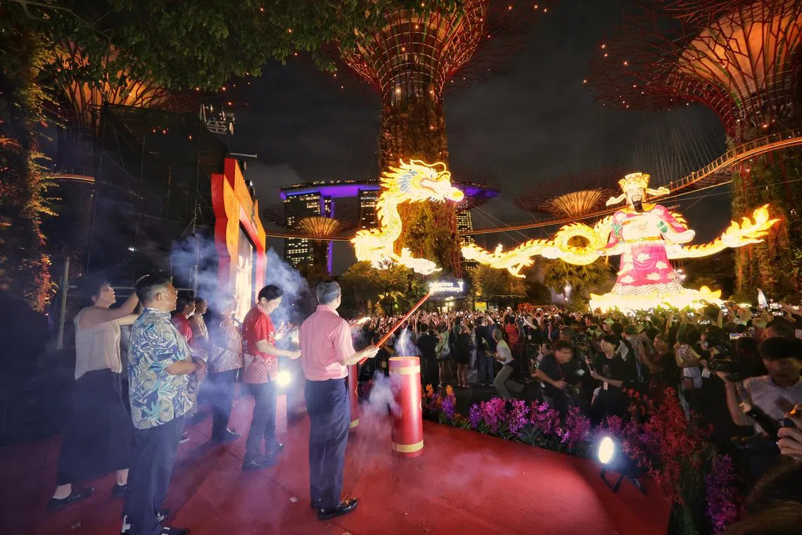 (From right, on stage) Minister for Culture, Community and Youth Edwin Tong, Deputy Prime Minister Lawrence Wong and Singapore Federation of Chinese Clan Associations (SFCCA) President Thomas Chua officiating the River Hongbao 2024 opening ceremony at Gardens by the Bay on Feb 8, 2024. ST PHOTO: KEVIN LIM 