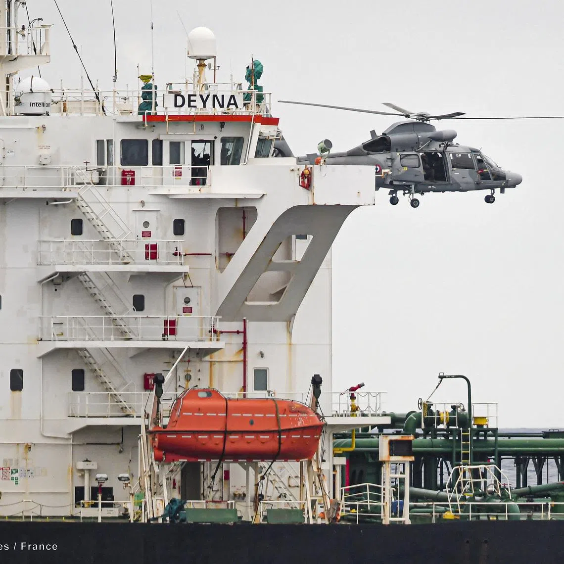 A French Navy helicopter hovers over the Deyna vessel, which is supposed to be a member of the Russian shadow fleet, during an operation  in the Western Mediterranean Sea, in this handout image obtained by Reuters on March 20, 2026. Prefecture maritime de la Mediterranee/Etat Major des Armees/Handout via REUTERS