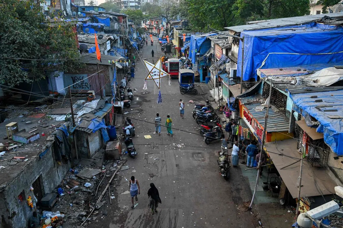 Residents walk through a street along the Dharavi slums, on Nov 2, 2022.