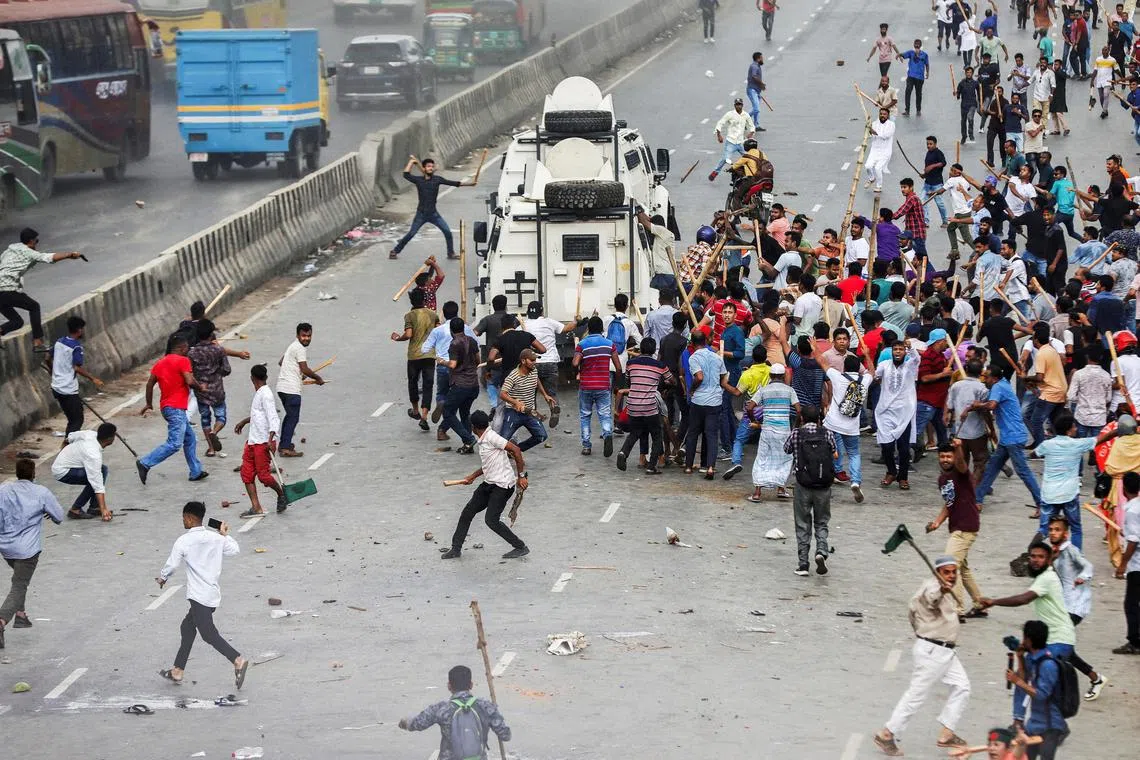 Supporters of the Bangladesh Nationalist Party (BNP) attack armed vehicles of police at Shonir Akhra area, during their sit-in rallies on the main entry points of the capital Dhaka, Bangladesh, July 29, 2023. REUTERS/Mohammad Ponir Hossain     TPX IMAGES OF THE DAY     