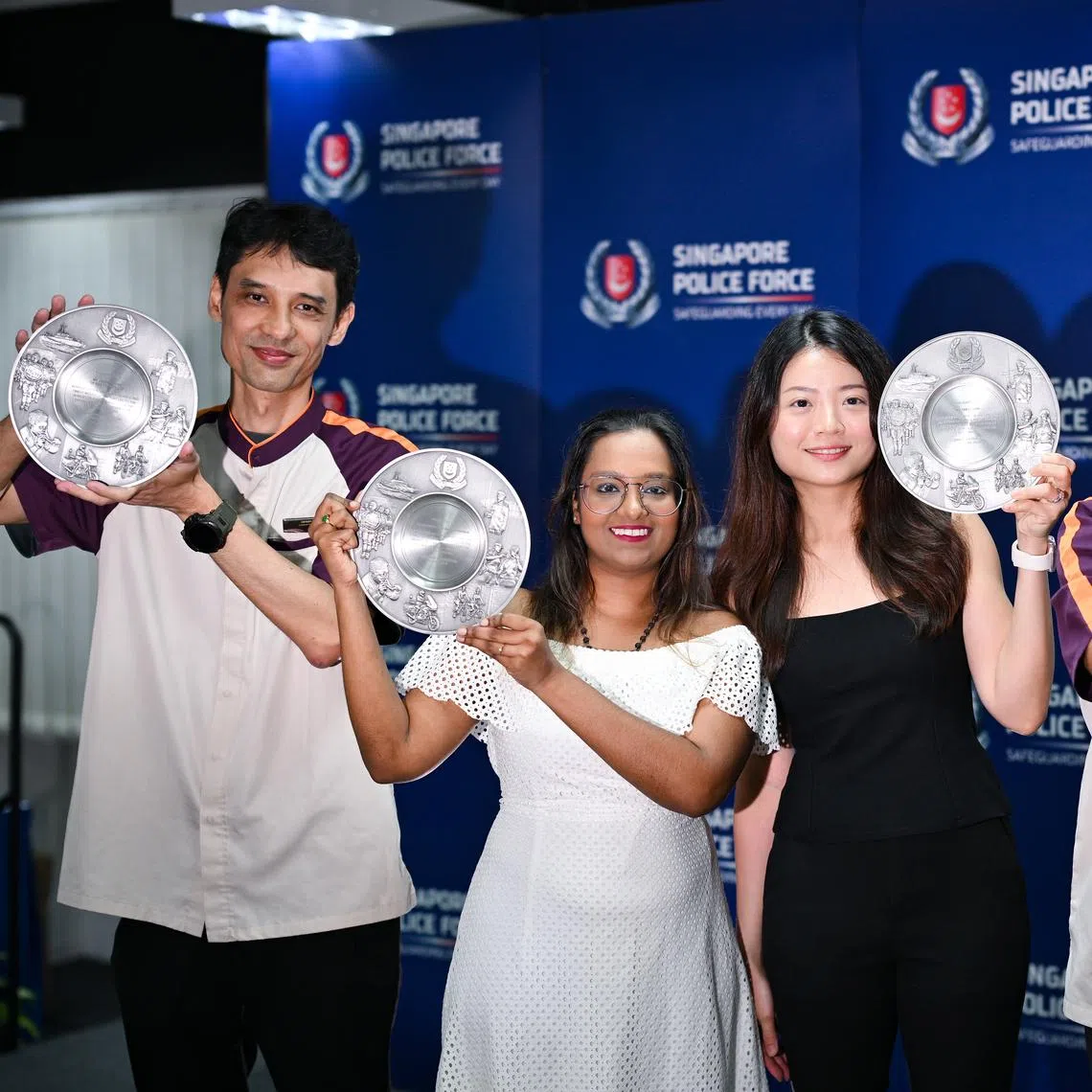 ST20260430-202615300442-Lim Yaohui-Justine Ong Min Si-joaward30/ Ms Tan Li Nian, (third from left) 32, KYC analyst and Ms Yasodhaa Balakrishnan, (second from left) 39, Assistant Manager with their SaferSG Public Spiritedness Awards together with SBS Transit Rail staff, Mr Jansen Heng, (extreme left) 51, Customer Service Officer and Mr Desmond Dexter John, (extreme right) 64, Assistant Station Manager, with their SaferSG Partner (Individual) Awards, during the award ceremony for the Public Spiritedness Award (PSA) and Community Partnership Award (CPA) by Public Transport Security Command  (TransCom) at Transcom HQ on April 30, 2026.   During the ceremony, two members of the public will receive the PSA and six public transport staff from SMRT Corporation and Tower Transit Singapore will receive the CPA. In addition, one member of the public will be receiving a letter of appreciation. The recipients had assisted in separate cases relating to molestation, voyeurism, and public nuisance. The award recipients demonstrated bravery and civic mindedness, their public spiritedness, and their strong community partnership with the Police. Their actions played a crucial role in detecting and preventing crimes. (ST PHOTO: LIM YAOHUI)
