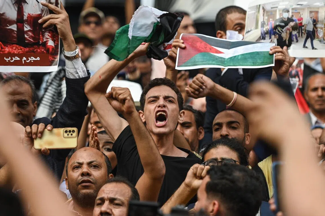 Demonstrators shout slogans during a protest in support of the Palestinian people, in Cairo, Egypt.