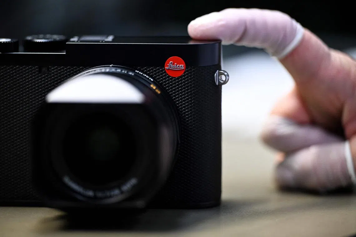 A small Leica logo is pictured at the Leica factory in Wetzlar, western Germany, on March 18, 2025. Born in Wetzlar, in central Germany, the brand with the red dot still fascinates and asserts its niche position in a market dominated by Japanese giants such as Sony, Canon and Nikon.
Although the Leica optics and microscope manufacturing company was founded in 1869 by entrepreneur Ernst Leitz, it was in 1925 that it presented its first 35mm camera model, which laid the foundations for modern photography. (Photo by Kirill KUDRYAVTSEV / AFP) / TO GO WITH AFP STORY BY JEAN-PHILLIPPE LACOUR
