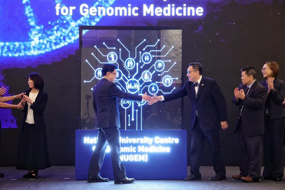 National Research Foundation chairman Mr Heng Swee Keat (centre left) and Professor Chong Yap Seng, deputy chief executive (Education and Research) of National University Health System (NUHS) and Dean of the National University of Singapore Yong Loo Lin School of Medicine, shaking hands to mark the launch of the National University Centre for Genomic Medicine by NUHS during its biennial Scientific and Innovation Summit at Shangri-La Hotel on April 2, 2026. ST PHOTO: KEVIN LIM azgenome02