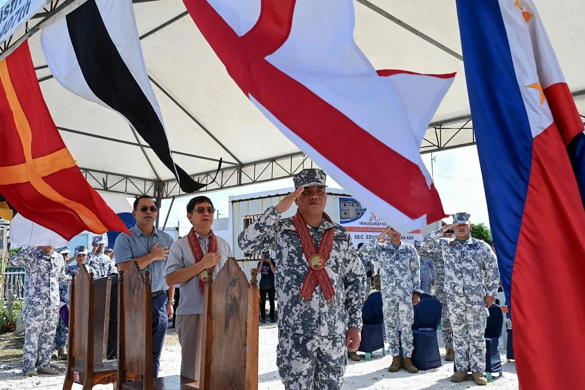 National Security Adviser Eduardo Ano (centre) made the announcement during a visit to the Philippine-held Thitu Island.