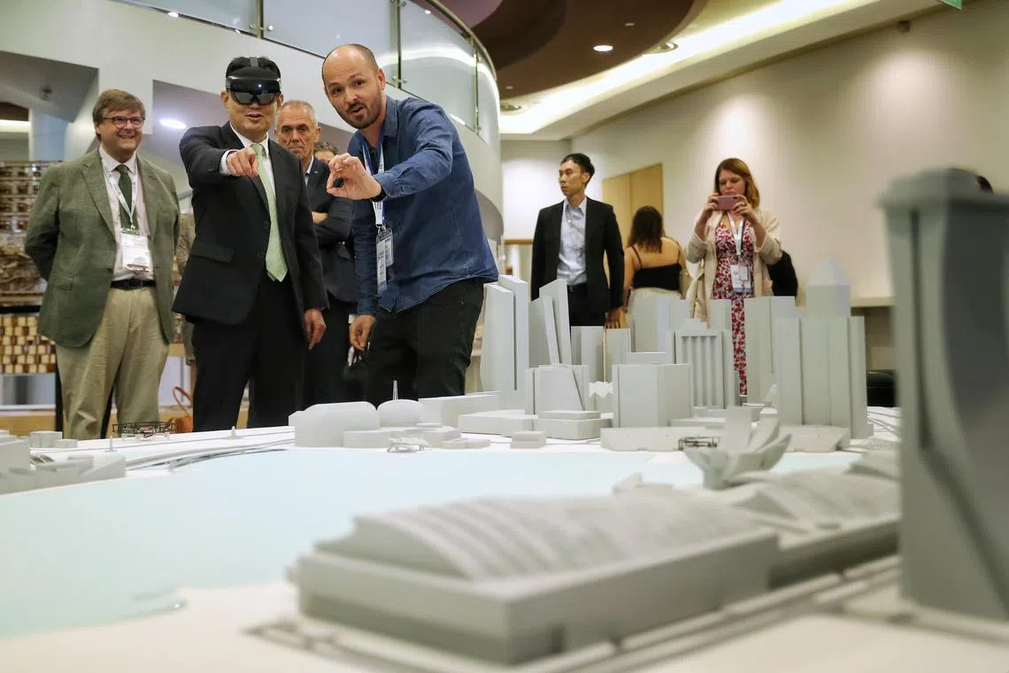 ST20230710_202397821657: Gin Tay/azcreate10/ Zhaki Abdullah /

Deputy Prime Minister Heng Swee Keat trying out the Augmented reality goggles that show the behaviour of the wind in the city, during the Create Symposium 2023.  With him are,
 (L-R): Professor Francisco Chinesta, Director or the Descartes Program;

Professor Antoine Petit (third from left) Director of CNRS (French National Centre for Scientific Research); and 

Dr Julien Castet(in blue shirt) , Head of Research at Immersion.