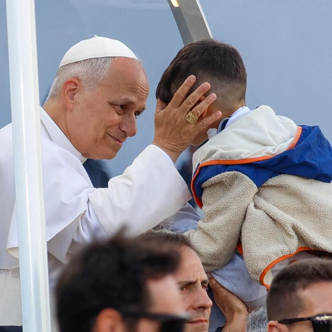 Pope Leo XIV blesses a child from the popemobile as he arrives to lead a Mass at the Gran Canaria Stadium in Las Palmas on the Canary Island of Gran Canaria on June 11.