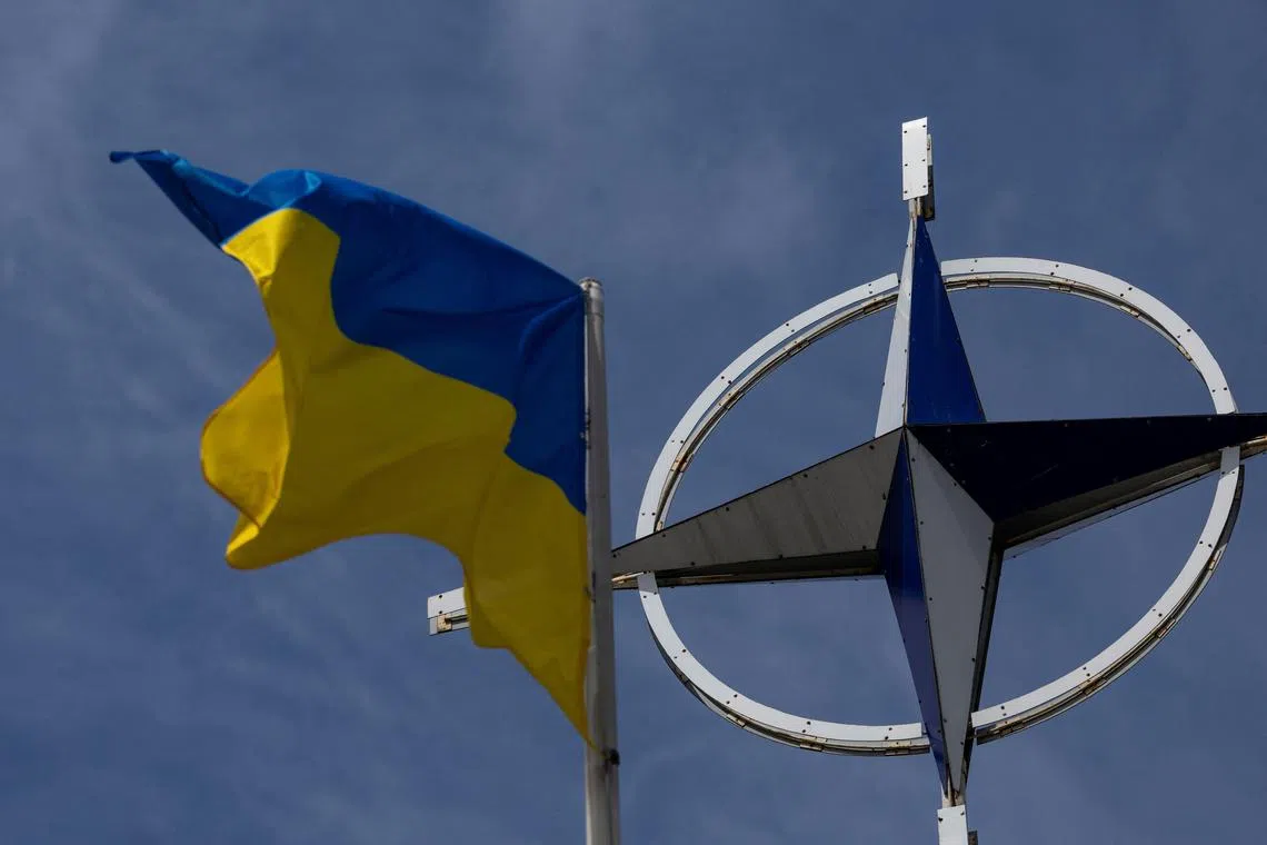 FILE PHOTO: A Ukrainian national flag rises in front of the NATO emblem, amid Russia's attack on Ukraine, in central Kyiv, Ukraine July 11, 2023. REUTERS/Valentyn Ogirenko/File Photo