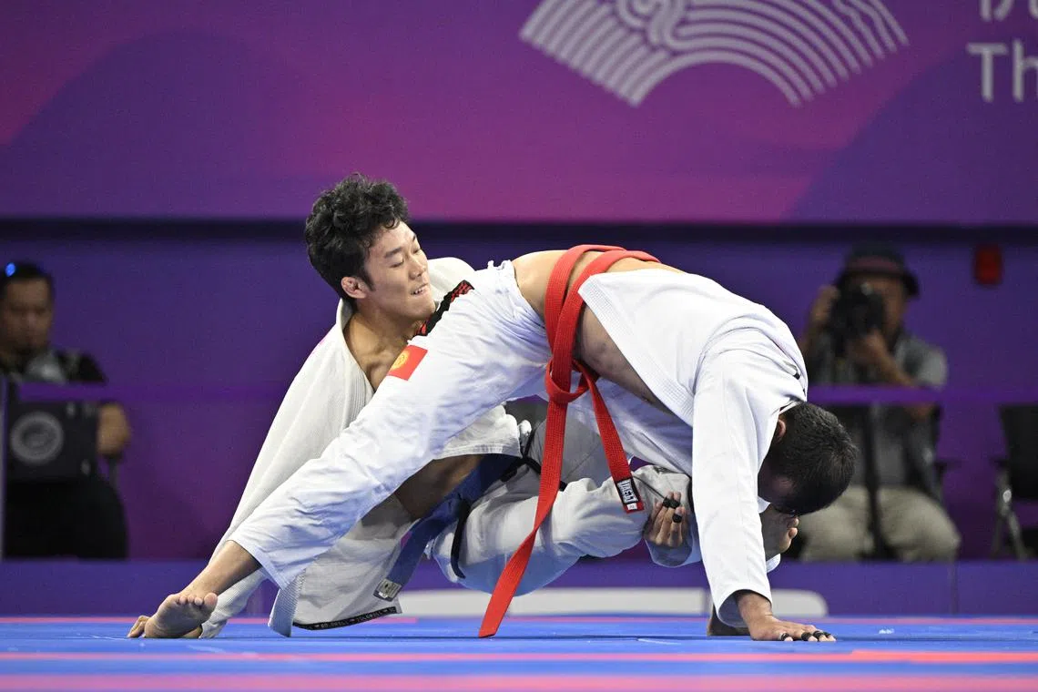 Singapore's Paul Lim (left) clinched the Republic's first medal in ju-jitsu at the Hangzhou Asian Games with his bronze.