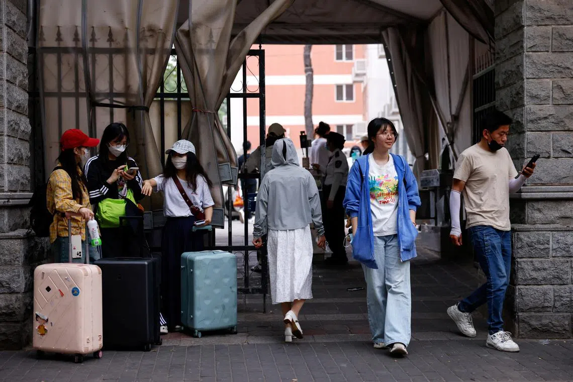 Postgraduate student Lainey, who is waiting to resume visa process to study a PhD in the U.S., walks out of her university campus, during an interview with Reuters, in Beijing, China May 30, 2025. REUTERS/Tingshu Wang