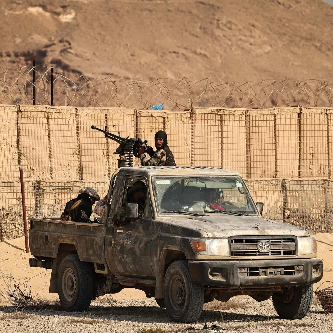 This photograph taken on January 20, 2026 during a tour for the foreign media organised by the Saudi-backed Yemeni government shows Saudi-backed Yemeni forces in the city of Mukalla in Yemen's coastal southern Hadramawt province. Saudi-backed Yemeni officials on January 19 said the United Arab Emirates has been running secret prisons in the country's south, the latest episode in a growing rift between the two regional allies turned rivals. The UAE and Saudi Arabia entered the Yemen war in 2015 as a united front backing the government against Iran-backed rebels. But they later supported rival factions within Yemen's internationally recognised government. A brief land grab by UAE-backed separatists infuriated Riyadh, which rolled them back. (Photo by Fadel SENNA / AFP)