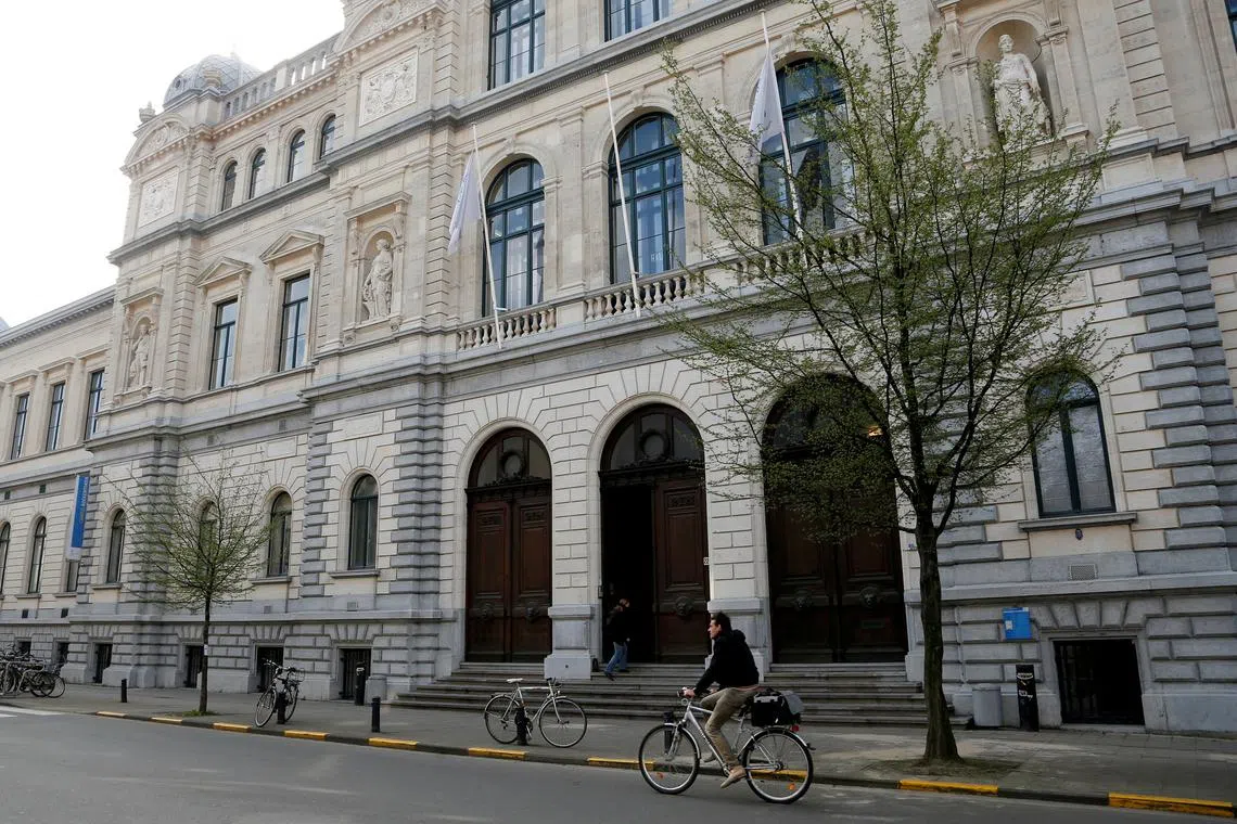 FILE PHOTO: A cyclist rides past a building of Ghent University, Belgium, April 4, 2017.  REUTERS/Francois Lenoir/File Photo