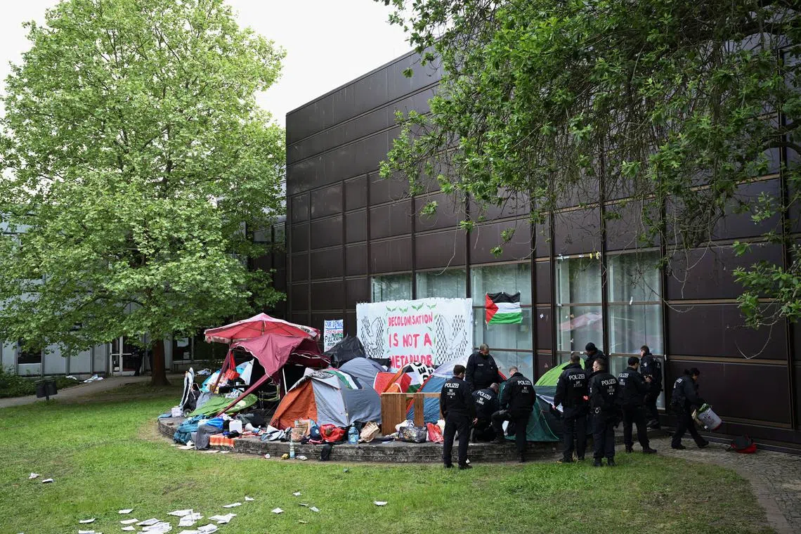 Police officers start to clean up the area where pro-Palestinian demonstrators occupied a courtyard at Freie Universitat (FU) Berlin with a protest camp, amid the ongoing conflict between Israel and Palestinian Islamist group Hamas, in Berlin, Germany, May 7, 2024. REUTERS/Annegret Hilse