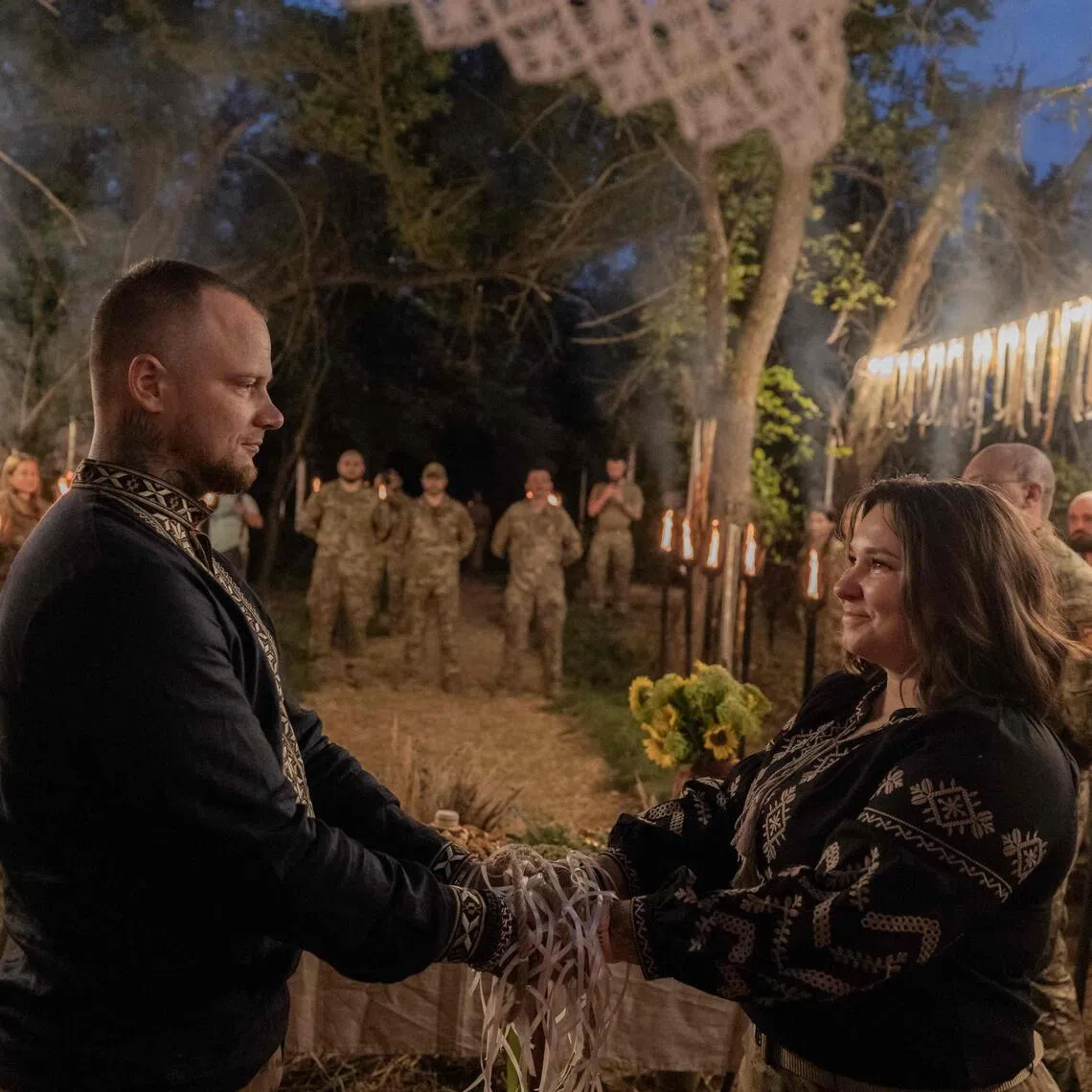 Two soldiers exchanged wedding vows during a Slavic ritual honouring ancestors and fallen warriors.