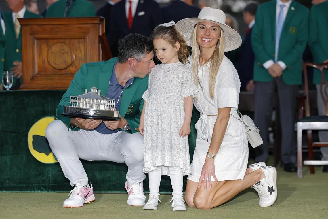 Rory McIlroy posing with his daughter Poppy and wife Erica after winning the Masters at the Augusta National Golf Club on April 13. 
