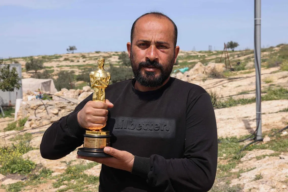 Palestinian filmmaker Hamdan Ballal posing with his Oscar for No Other Land in his village of Susya, in the south of the occupied West Bank, on March 26. 