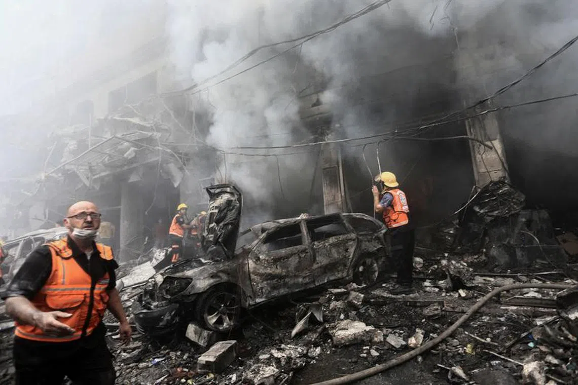 Palestinian rescuers work at the site of Israeli strikes, in Jabalia refugee camp, in the northern Gaza Strip October 9, 2023. REUTERS/Mahmoud Issa