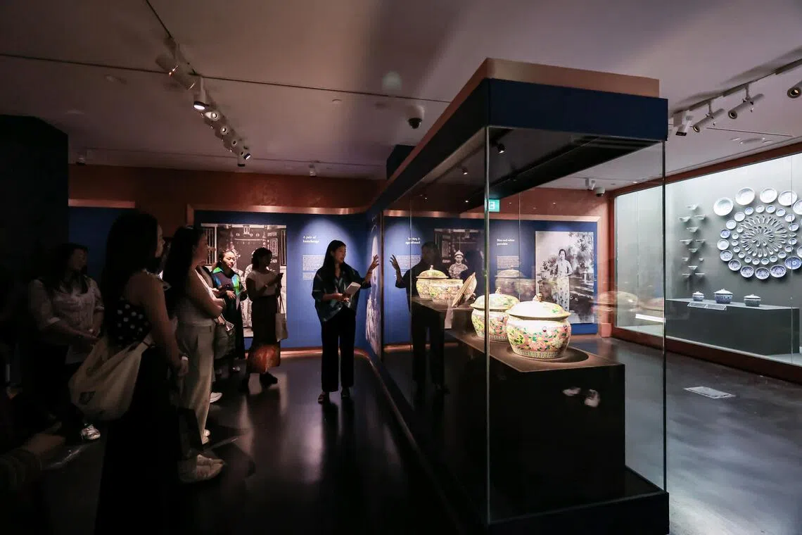 Curator Naomi Wang (centre) giving invited guests a tour of the Exceptional/Everyday: New Acquisitions, New Perspectives exhibition during the preview at Peranakan Museum on Oct 27.