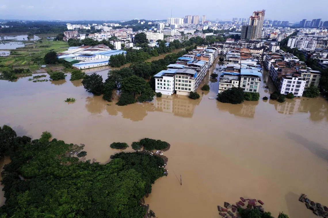 FILE PHOTO; A drone view shows buildings partially submerged in floodwaters after heavy rainfall caused Wuming river to overflow, in Nanning, Guangxi Zhuang Autonomous Region, China June 19, 2024. cnsphoto via REUTERS/File Photo
