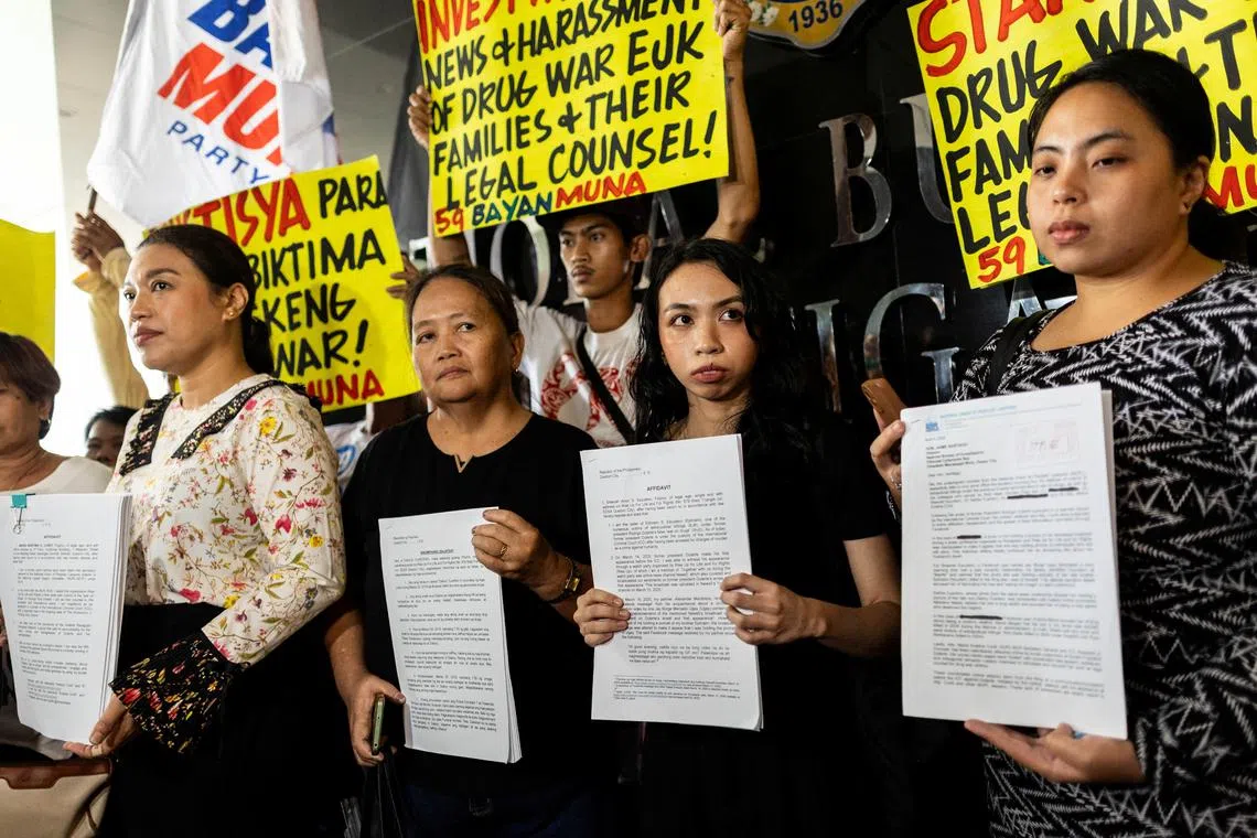 Kristina Conti, a human rights lawyer, representing victims of the war on drugs, along with Sheerah Escudero and Dahlia Cuartero, relatives of drug war victims, and Katherine Panguban of the National Union of People's Lawyers, representing the victims, show their affidavits and a letter to the National Bureau of Investigation requesting a probe into the online harassment they have received following the arrest of former Philippine President Rodrigo Duterte, at the National Bureau of Investigation in Pasay City, Philippines, April 4, 2025. REUTERS/Eloisa Lopez