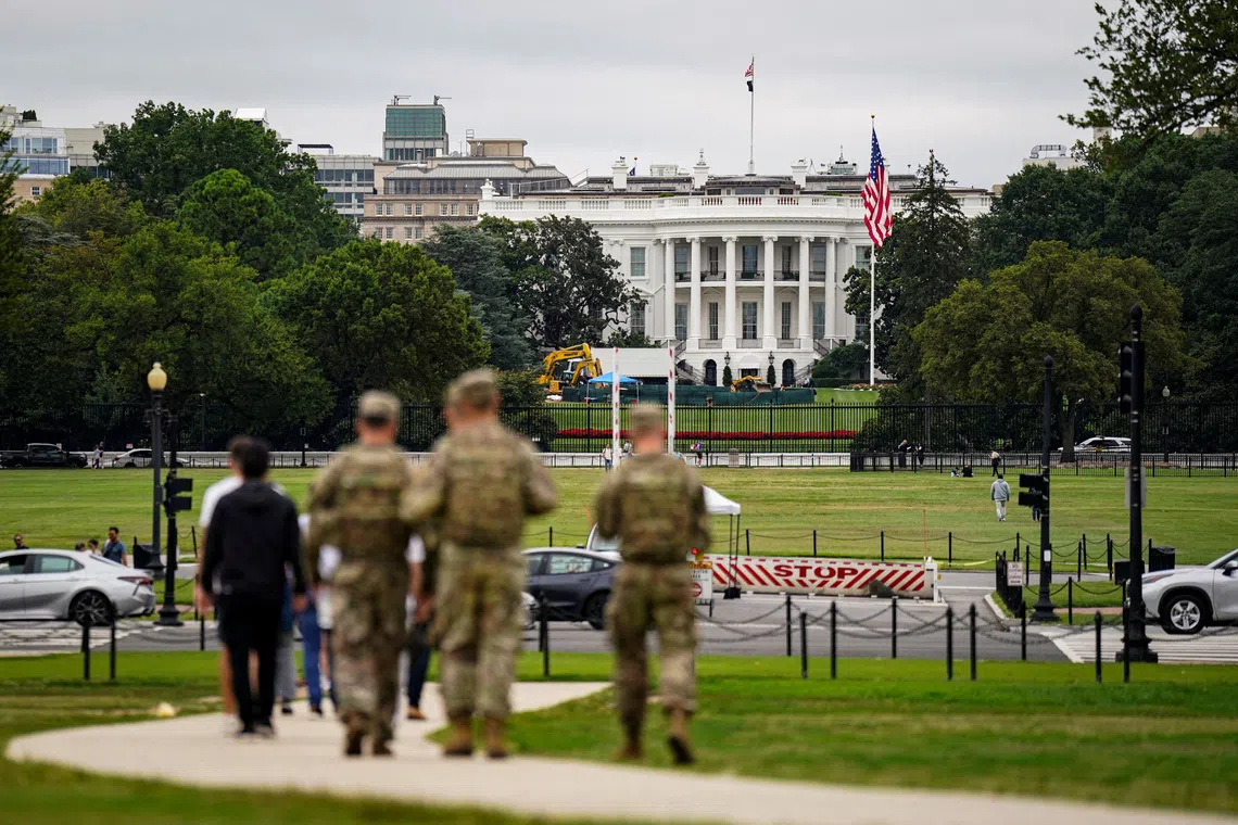 Members of the National Guard walk near the White House on the National Mall after U.S. President Donald Trump deployed the National Guard and ordered an increased presence of federal law enforcement to assist in crime prevention, in Washington, D.C., U.S., August 21, 2025. REUTERS/Al Drago