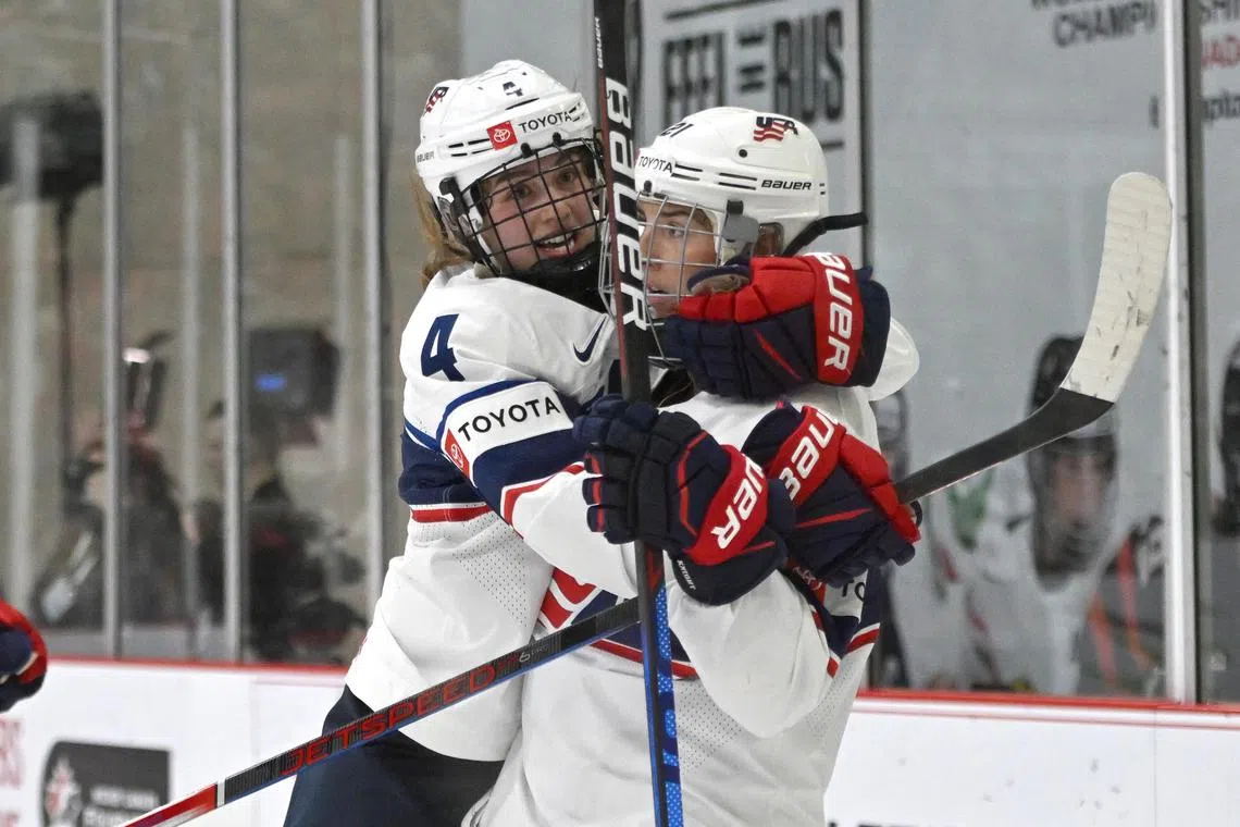 Unites States forward Hilary Knight (21) is embraced by defender Caroline Harvey (4) after scoring against Canada in the third period of the women’s world ice hockey championships at CAA Centre. She scored a hat-trick as the US won 6-3.