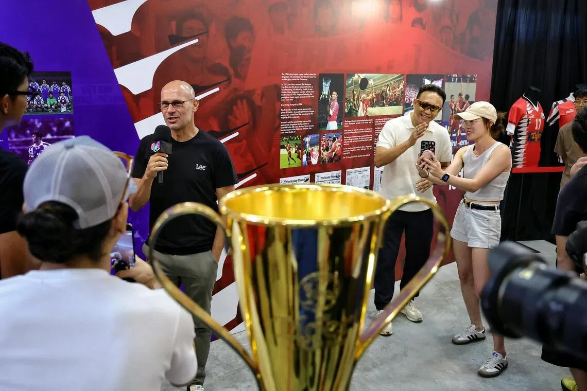 (From left) 1994 Lions Abbas Saad and Fandi Ahmad at the launch of the 1994 Legacy Collection cards on Nov 16. In the foreground is the Asean Championship trophy, which the Lions won in 1998, 2005, 2007 and 2012.