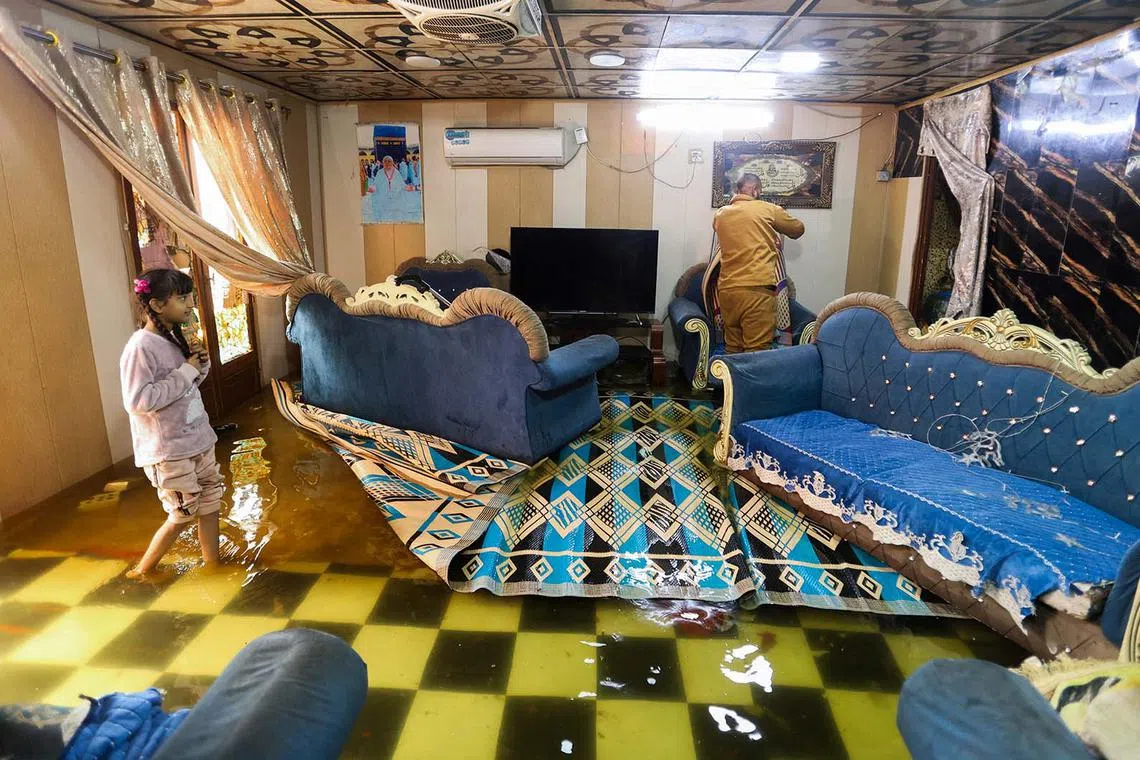 A girl walking in her home after heavy rainfall in Baghdad, Iraq, March 9, 2025. 
