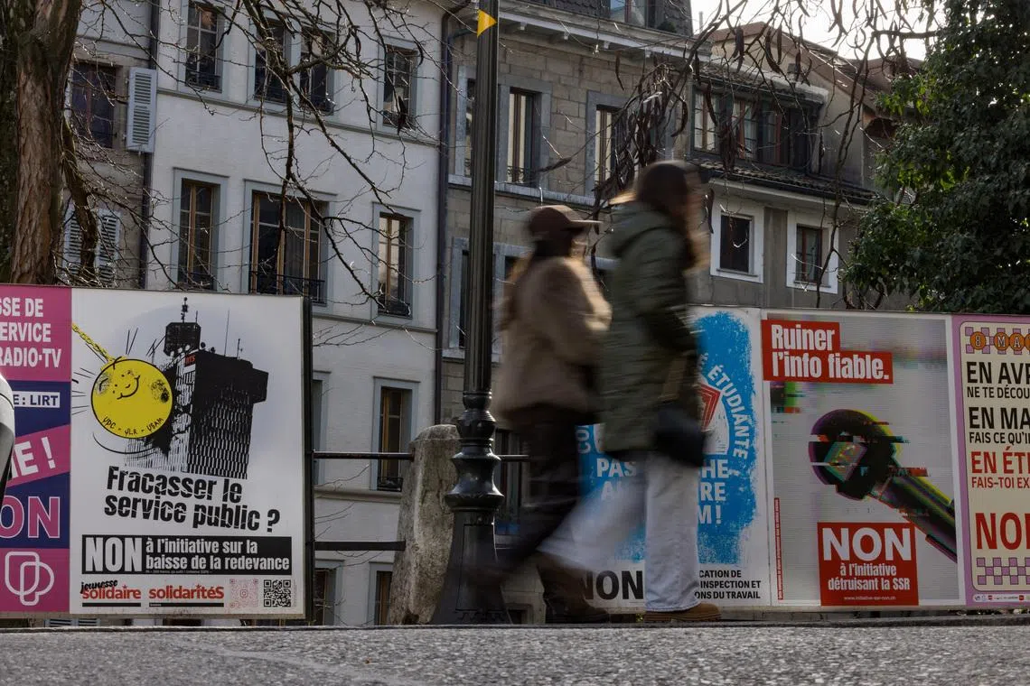 Posters encouring people to vote \"no\" to the funding cuts for the SRG SSR (Swiss Broadcasting Corporation), ahead of the upcoming Swiss national referendum on March 8, in Geneva, Switzerland, February 15, 2026. REUTERS/Pierre Albouy